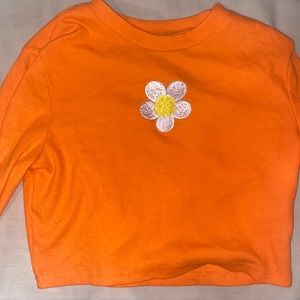 bright orange, long sleeve crop top with flower embroidery